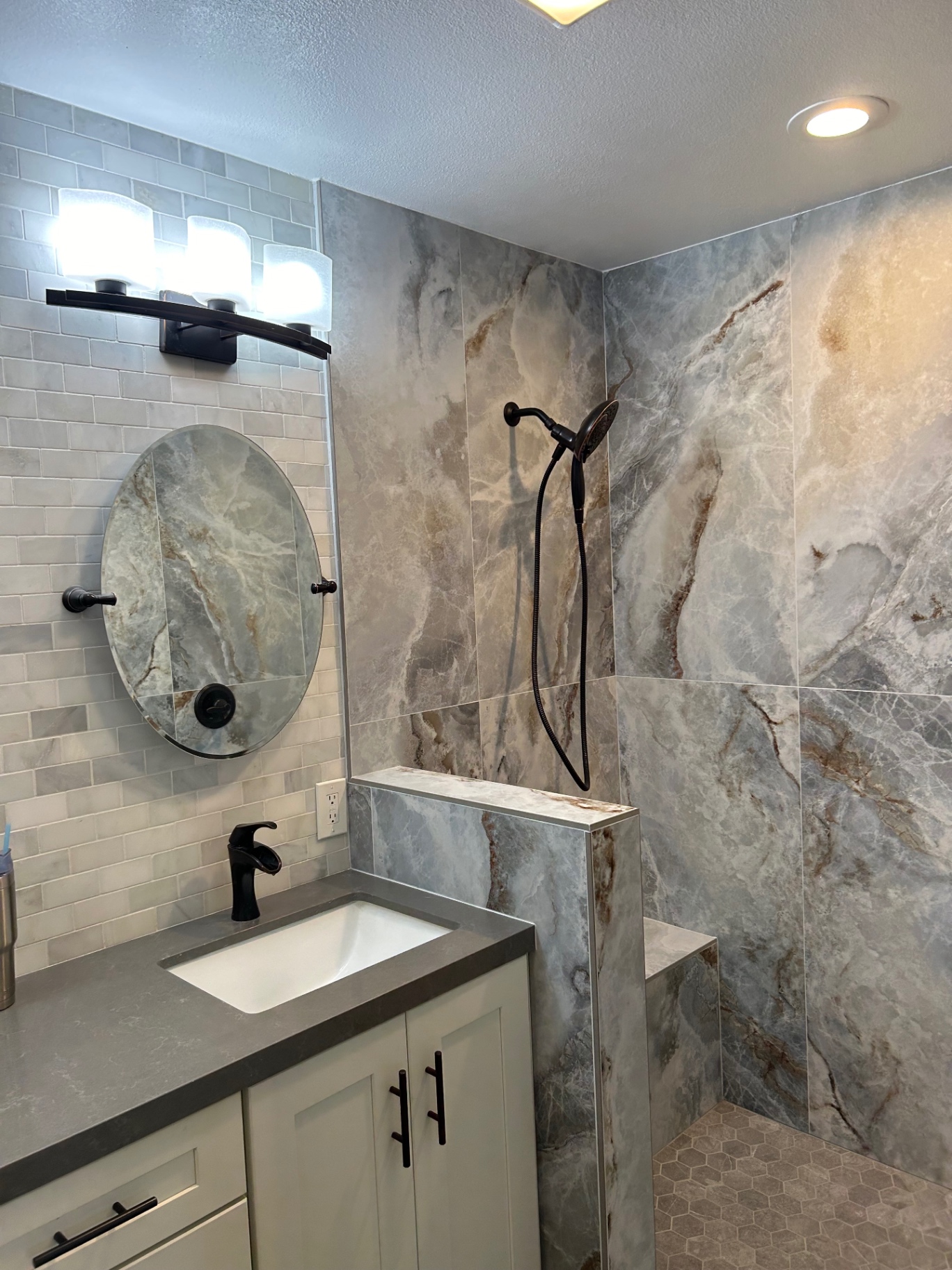 Bathroom remodel with onyx-look porcelain shower, hex floor and quartz vanity