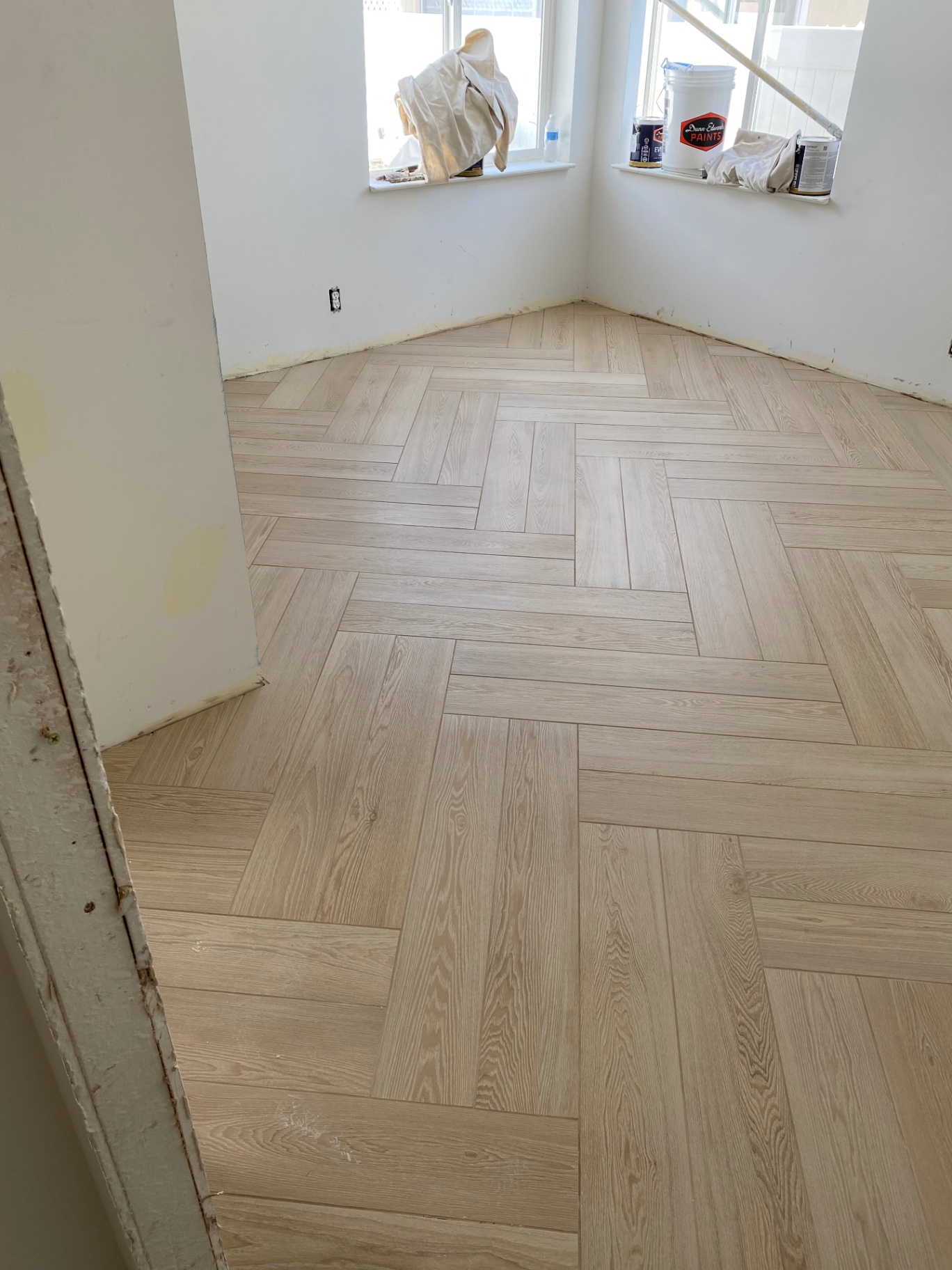 Light oak wood-look porcelain tile installed in herringbone pattern