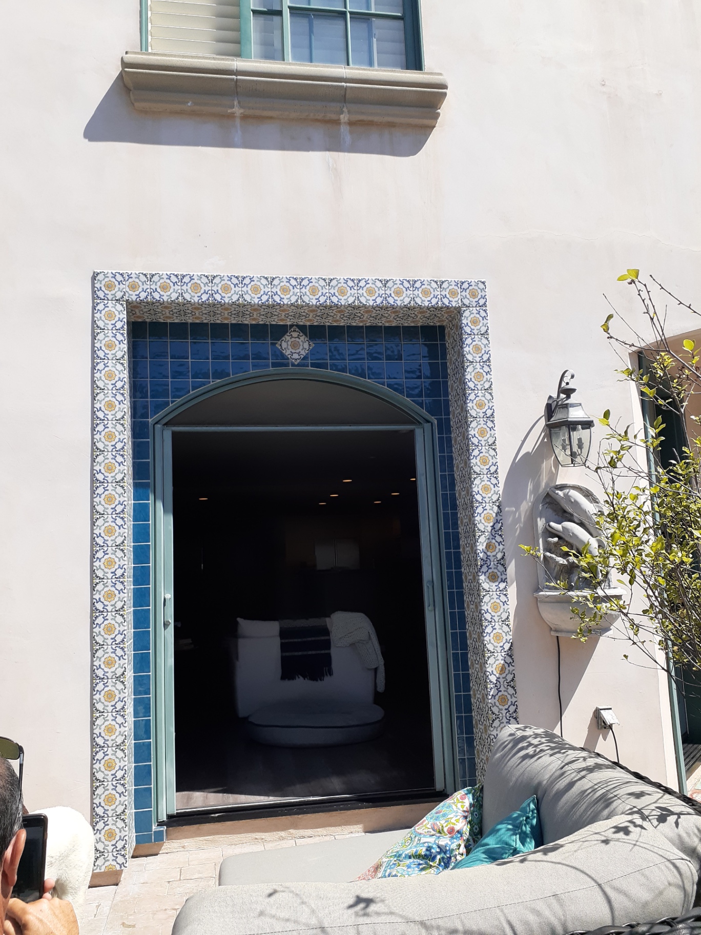 Blue Spanish tile arch detail framing an exterior doorway