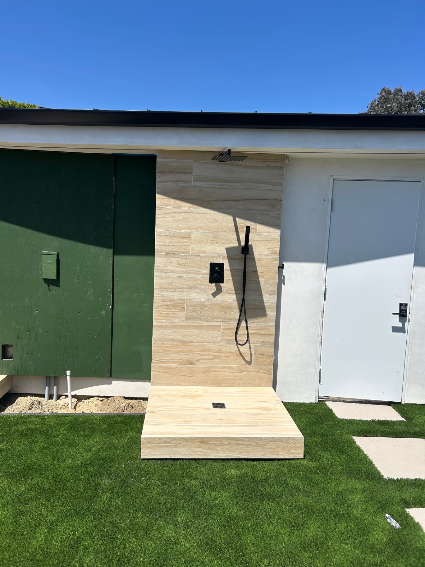 Completed outdoor shower with matte black fixtures
