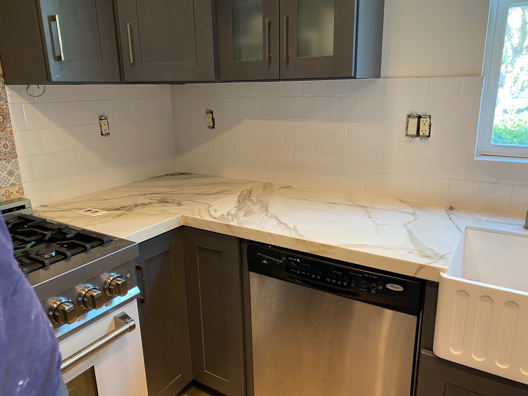 White subway tile kitchen backsplash with calacatta marble counter and farmhouse sink