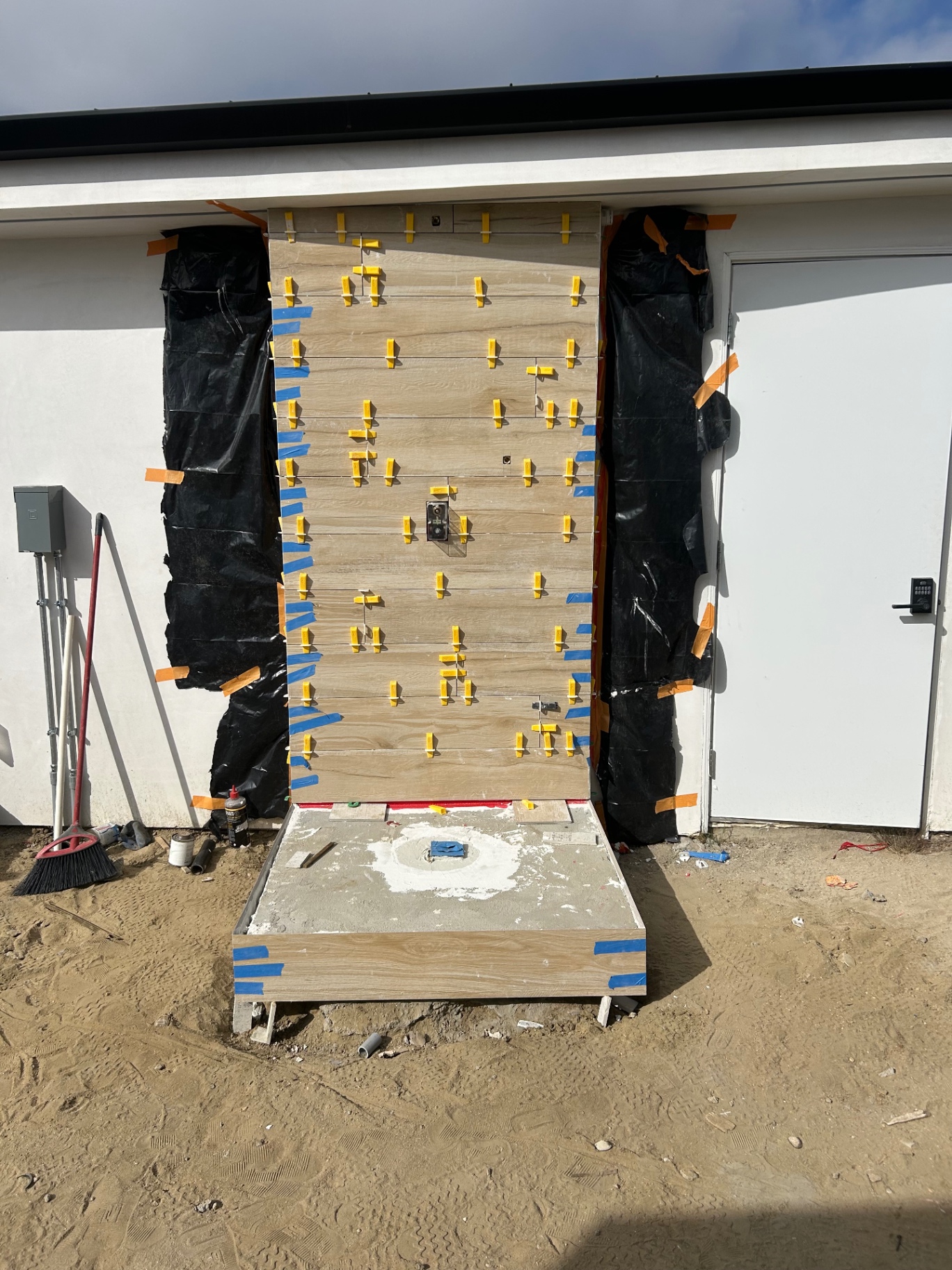 Wood-look porcelain tile being set with leveling clips