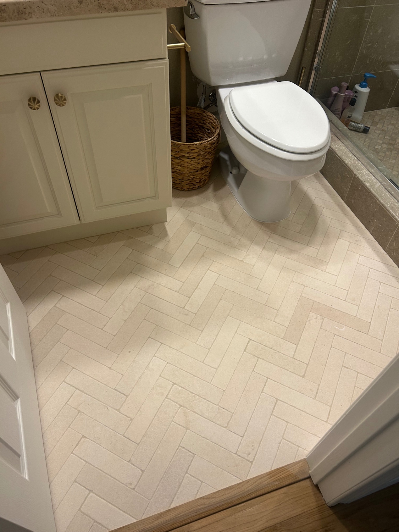 Cream herringbone tile bathroom floor