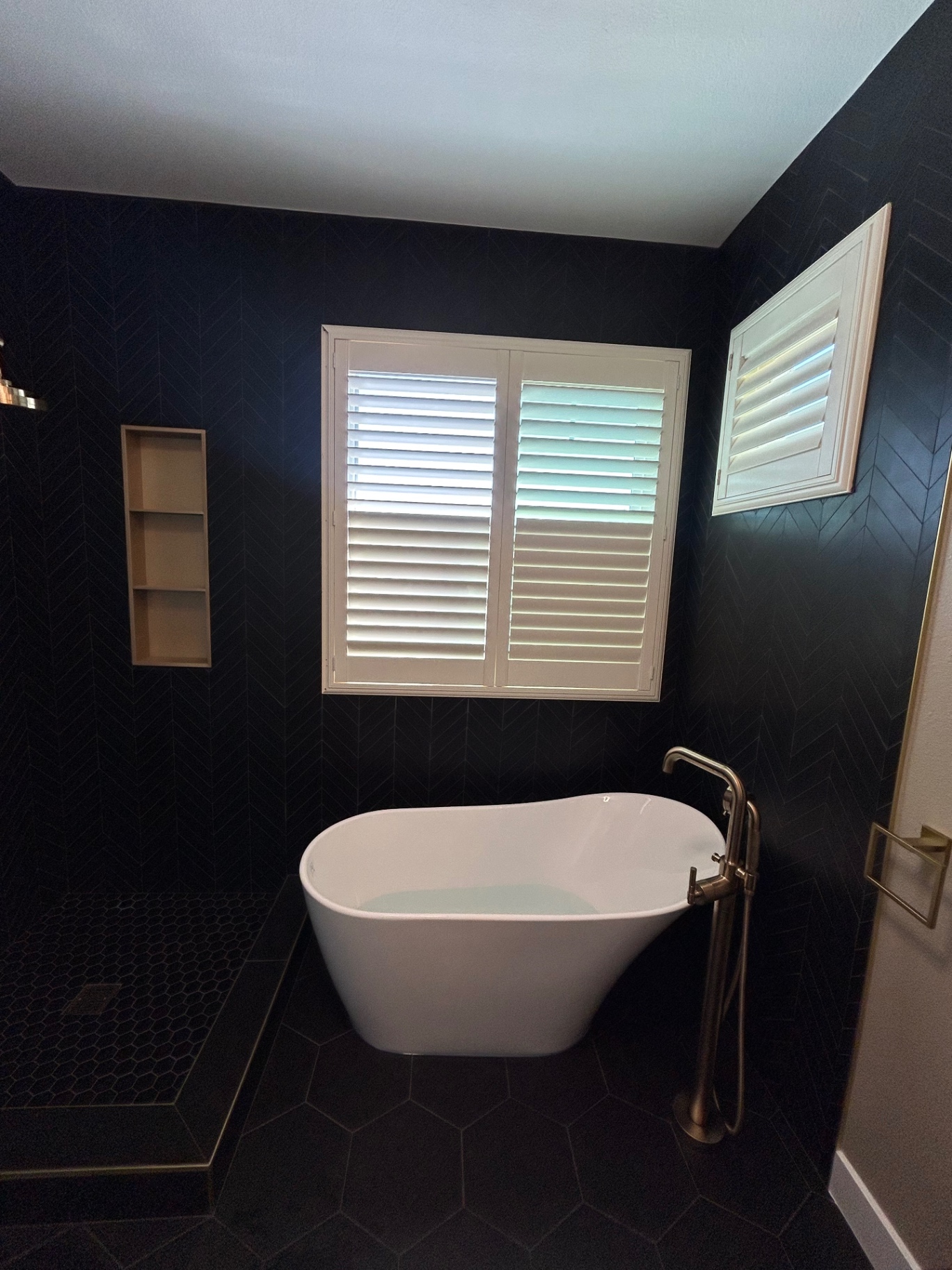 Dark chevron tile bathroom remodel