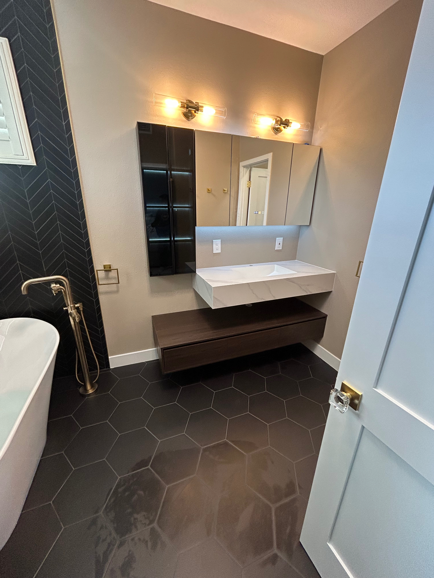 Bathroom with floating marble vanity and hexagon floor