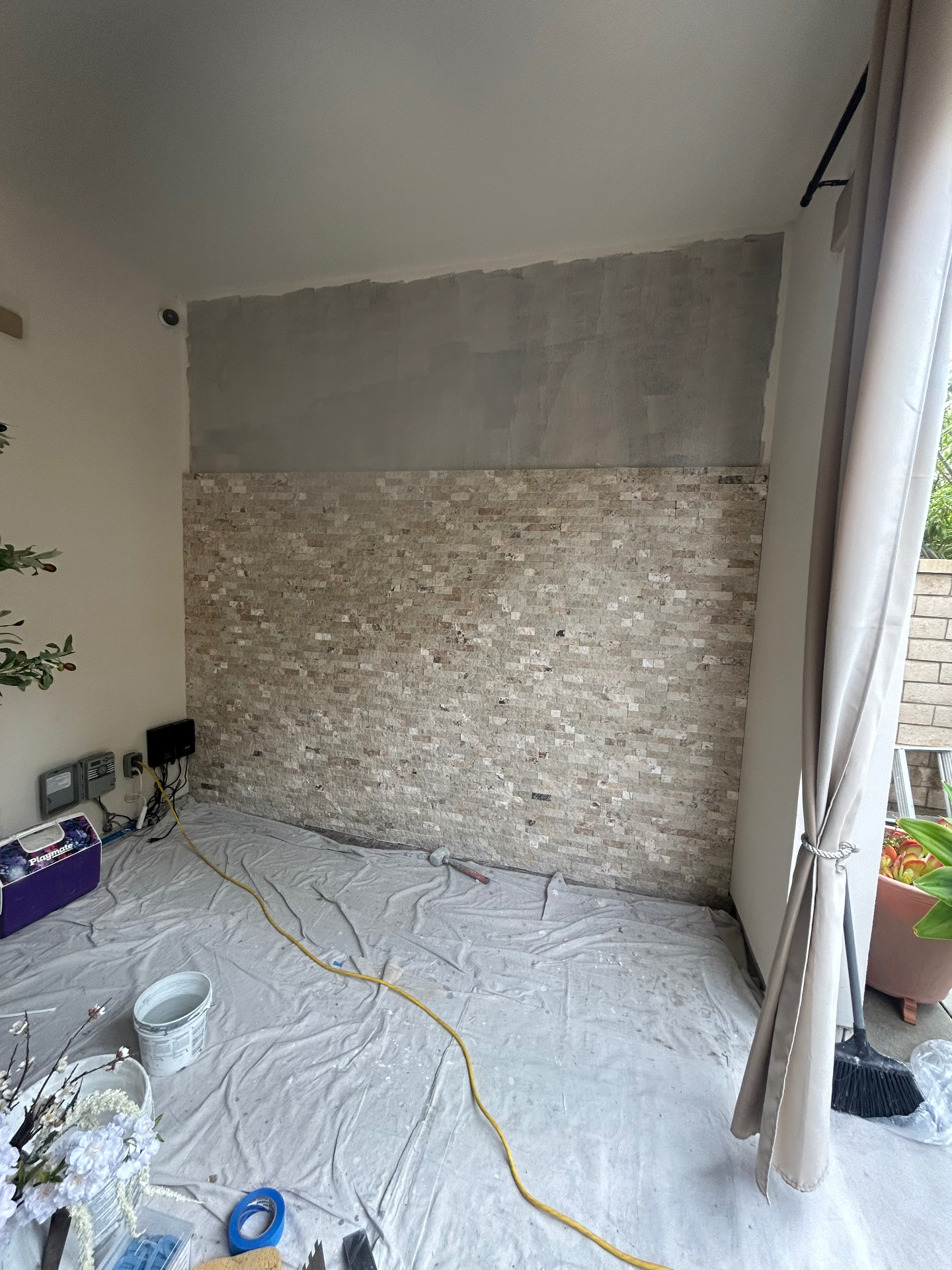 In-progress photo during stacked stone accent wall installation